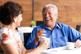 small size - blue shirt elderly man talking with woman at The Delaney at Georgetown senior living community