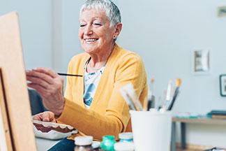 elderly woman painting at The Delaney at Georgetown - small size