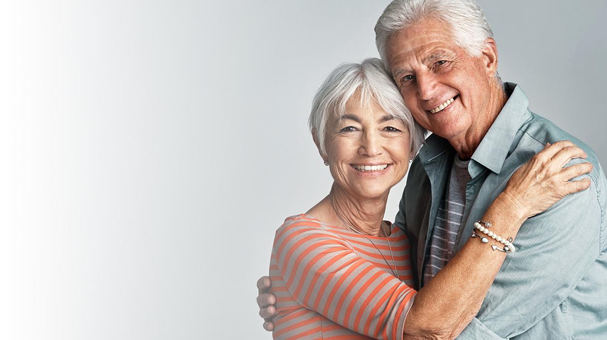 white fade with elderly couple hugging at The Delaney at Georgetown senior living