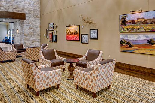 lounge area with paintings at The Delaney at Georgetown senior living community