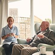 elderly man with woman chatting at The Delaney at Georgetown senior living community