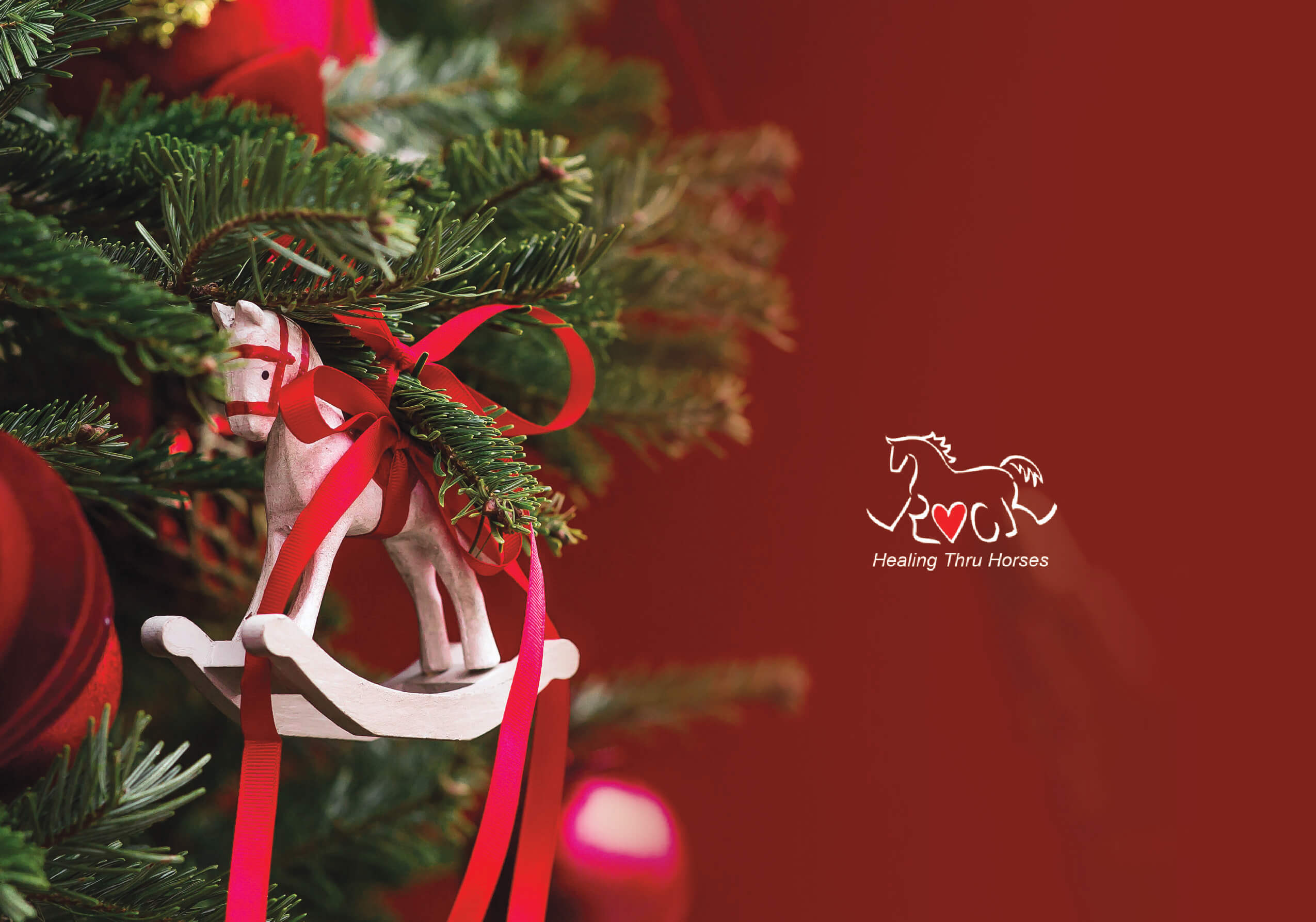 Christmas tree decorated with white and red rocking horse ornament