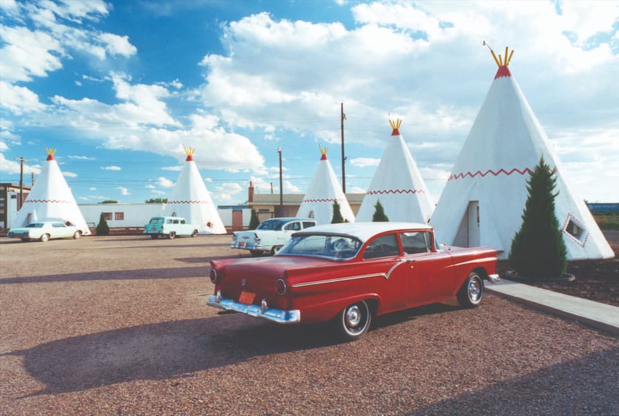 classic cars parked near teepee tents